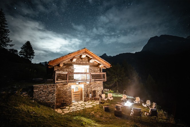 One of the outposts at night with a fire put set up outside.